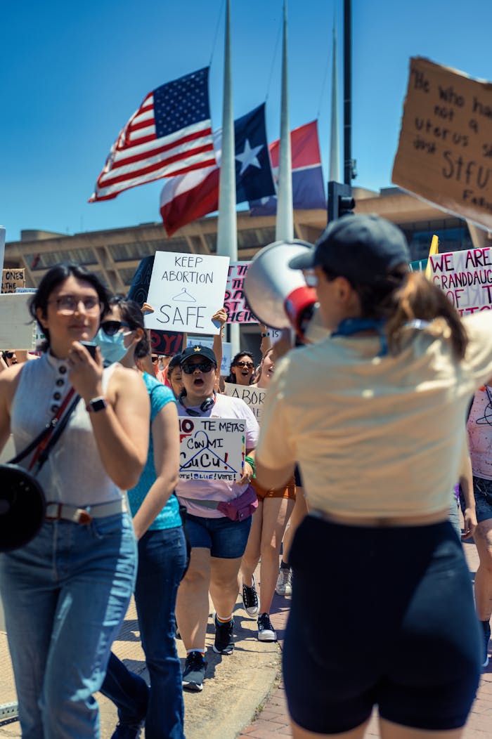 A vibrant street protest advocating for women's rights and nonviolent activism.