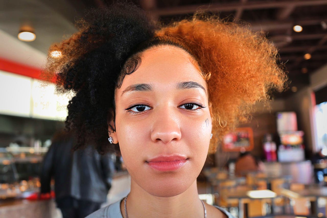 Close-up portrait of a stylish woman with afro hair at a cafe in Marietta, GA.