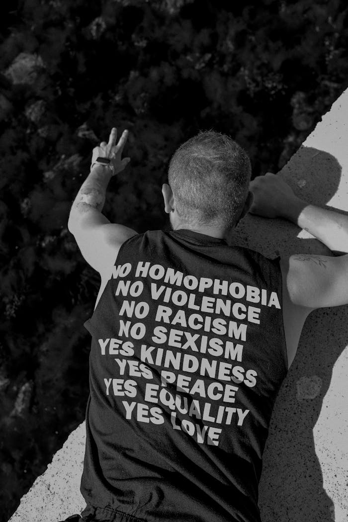 A black and white photo of a man with peace slogans on his shirt in Istanbul.
