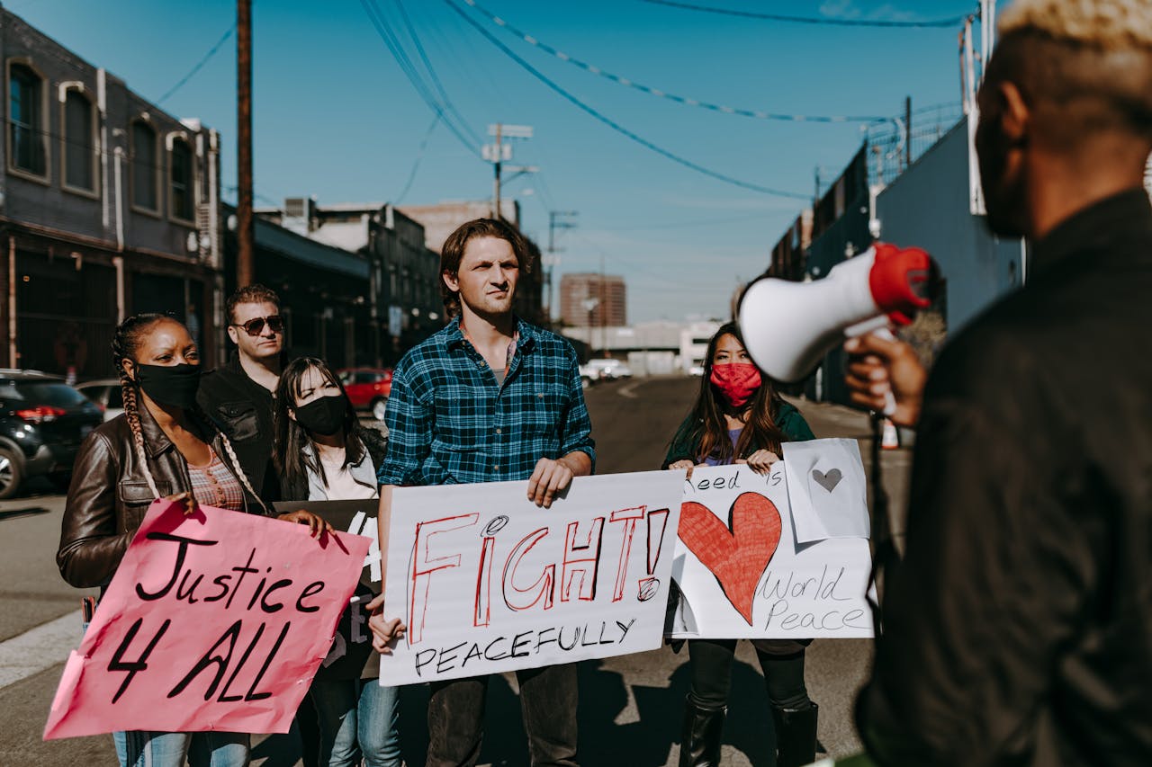 A diverse group of people peacefully demanding justice and equality in an outdoor protest.